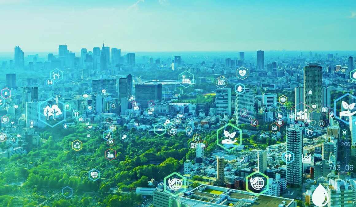 Aerial view of a city, featuring a wooded space and lots of skyscrapers. Across the image there are sustainability themed icons, such as water, plants, trees, recycling, a globe, knives and forks, cogs, solar panels, a wheelchair user, a graph showing results, and a heart.